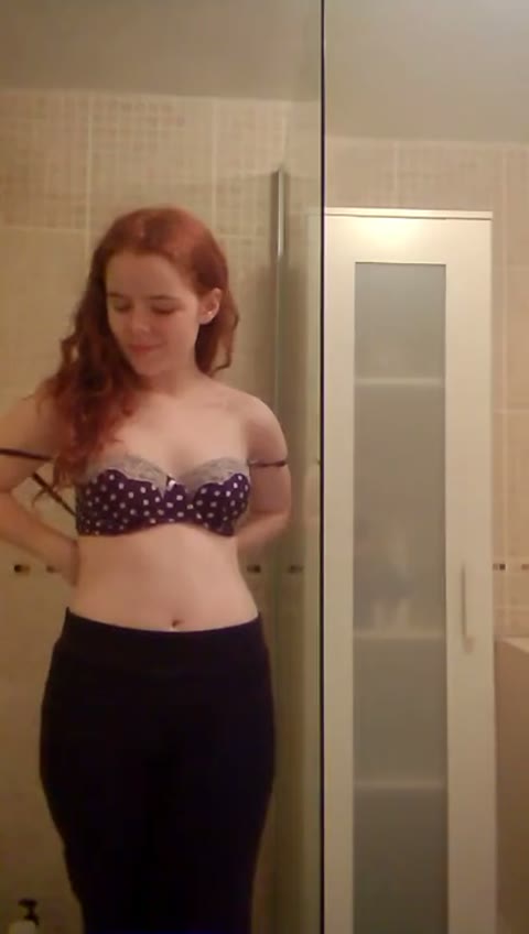 A young red haired girl undresses on camera – Picture Preview
