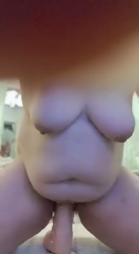 A mature plump girl is bouncing on a rubber dick