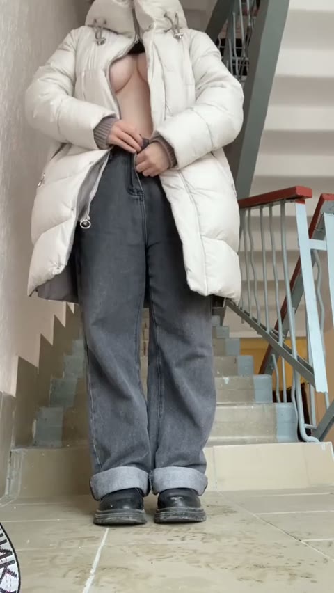 Irina undresses in the stairwell and masturbates